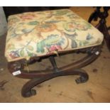 19th Century mahogany crossover stool having overstuffed seat with floral upholstery, carved details