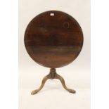 George III mahogany circular pedestal table, the dish top above a wrythen baluster column support
