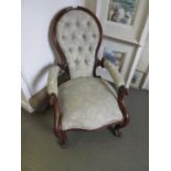 Victorian walnut button upholstered spoon back armchair having C-scroll carved arm supports and legs