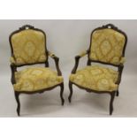 Pair of late 19th / early 20th Century French carved walnut open arm chairs in 18th Century style,