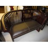 Modern hardwood two seat sofa by Global Art House having shaped comb back and leather upholstered