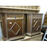 Pair of reproduction oak bedside cabinets with moulded panel doors and canted corners, together with