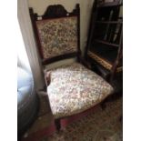Art Nouveau mahogany low seat side chair and matching armchair with floral upholstery, the