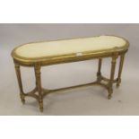 Late 19th / early 20th Century French giltwood stool, the oval moulded top above six turned tapering