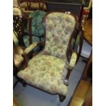 Victorian walnut and button upholstered open armchair with floral upholstery on turned front
