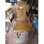 Victorian oak hall chair with an armorial back together with a box seat piano stool and an