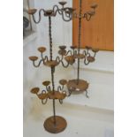 Pair of large iron tiered candelabra (at fault), 42ins high