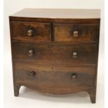 Small George III mahogany bow fronted chest of two short and two long drawers with knob handles,