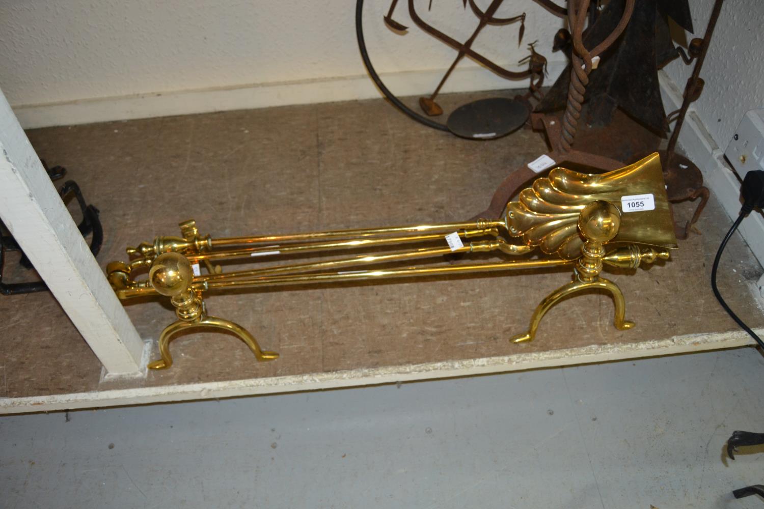 Set of three brass fire irons with dogs