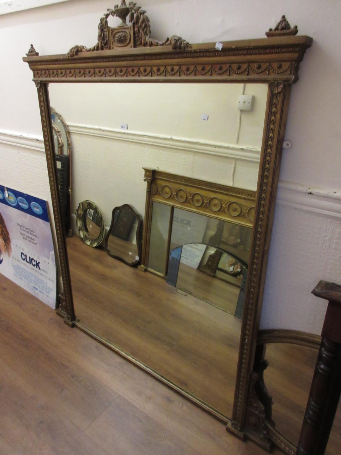 Large 19th Century gilded composition overmantel mirror with an urn and swag surmount and swag