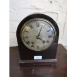 Early 20th Century mahogany dome shaped mantel clock with a circular silvered dial, Roman numerals