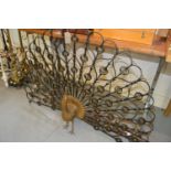 Mid 20th Century wrought iron and parcel gilt fire guard in the form of a peacock, 48ins x 31.5ins