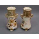 Pair of Zsolnay Pecs vases of two handled tapering design, decorated with flowers on a cream