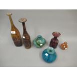 Two Mdina glass bottle vases, similar carafe, two blue glass vases and a paperweight