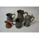 19th Century pewter quart baluster mug with scroll handle, two other pewter mugs, pewter tankard and