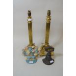 Pair of brass Corinthian column table lamps together with two painted iron door stops