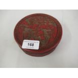 Chinese red cinnebar laquer circular box and cover decorated with figures in a landscape (