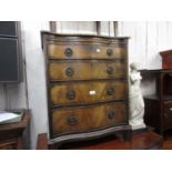 Small reproduction mahogany serpentine fronted chest with a brushing slide above four drawers on