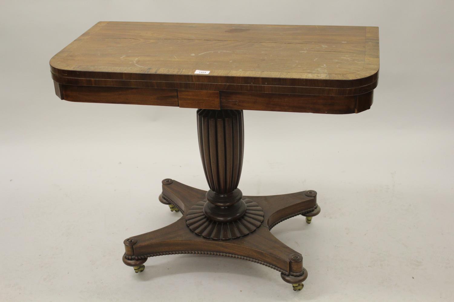 George IV mahogany rosewood crossbanded fold-over card table on fluted column and quadruped base (