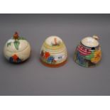 Group of three various Clarice Cliff Bizarre preserve jars with covers, Crocus pattern and