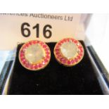 Pair of circular Indian yellow metal ear studs set large flat cut diamonds and a halo of rubies