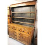 Early 19th Century oak dresser, the boarded shelf back above an arrangement of drawers and