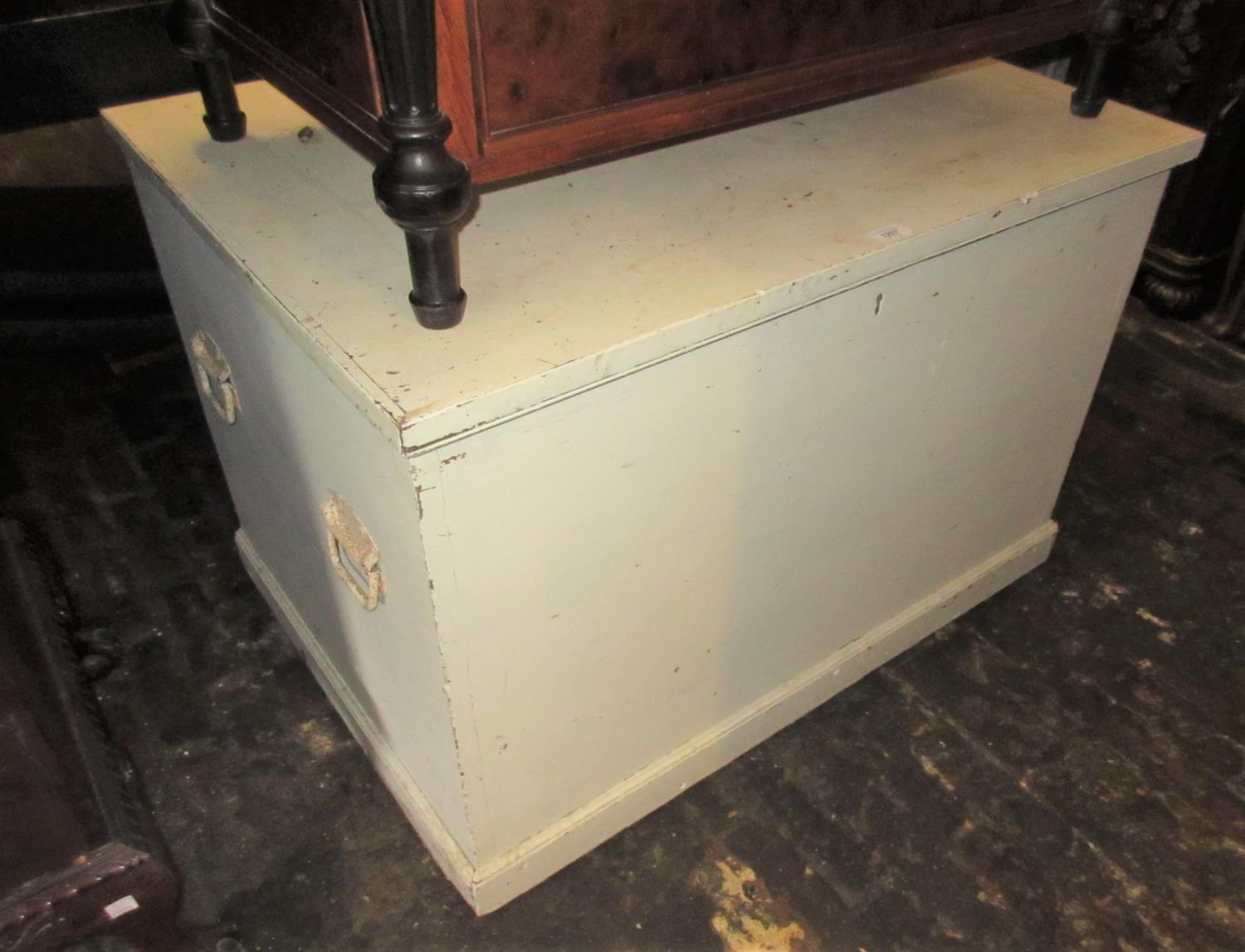 Large white painted pine trunk with hinged cover and iron end handles, 39ins wide