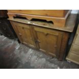 Oak side cabinet with two geometrically moulded panel doors on later bun feet, with a hinged top (