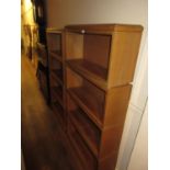 Pair of mid 20th Century pale oak modular bookcases with open shelves and stepped plinth bases