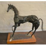 Mid 20th Century welded steel sculpture of a horse on a rectangular wooden plinth base, signed