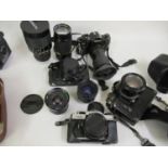 Quantity of photographic equipment to include three Canon A1 camera bodies with various lenses,