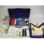 Leather case containing a quantity of various Masonic regalia, including two silver gilt medals