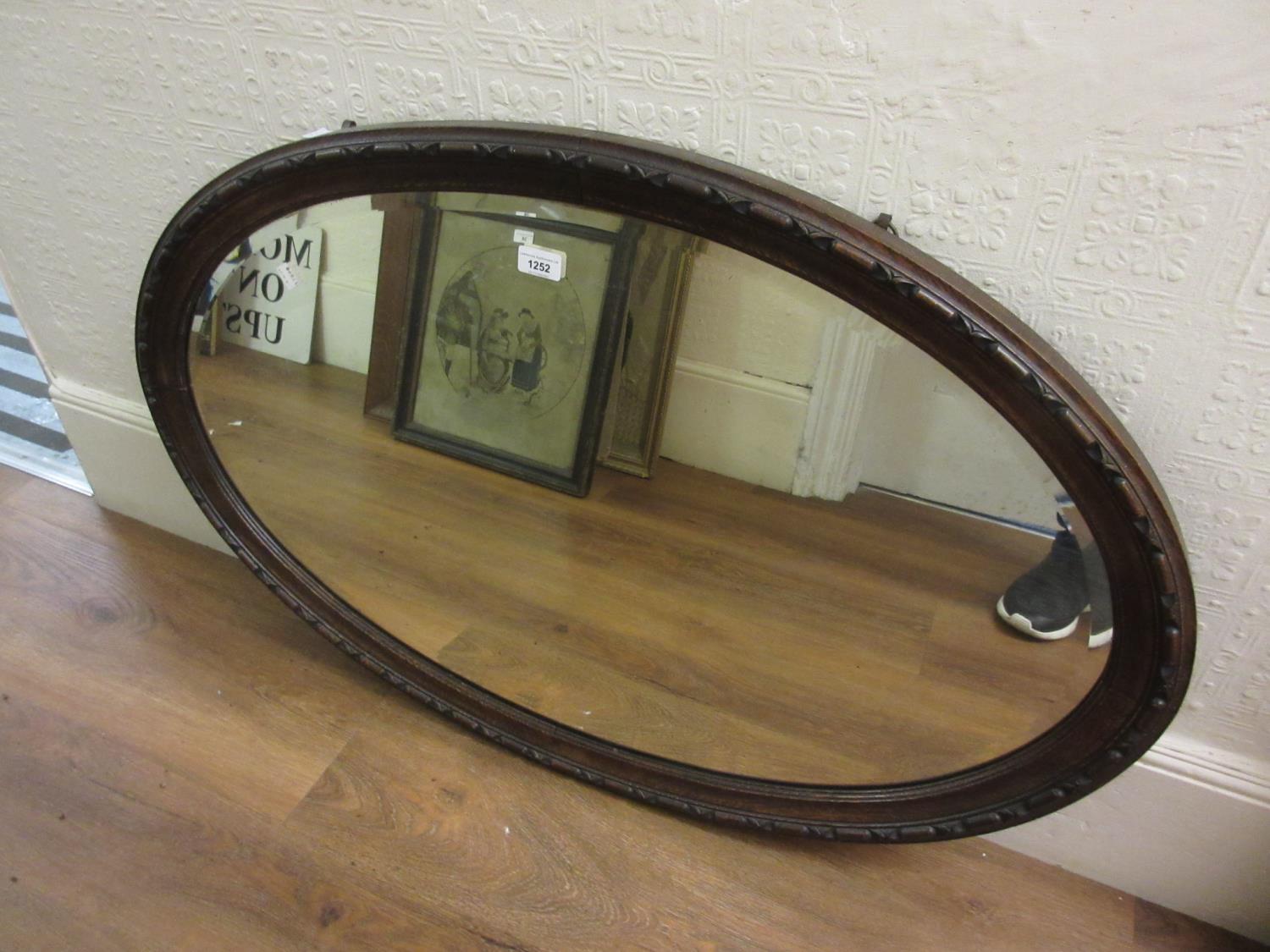 1930's Oval oak framed bevel edged wall mirror