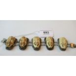 Unusual far eastern silver bracelet with five carved ivory maskhead panels
