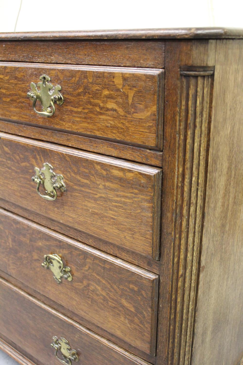George III oak chest of two short and three long drawers with brass handles and escutcheons, flanked - Image 2 of 2