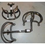 Three various black painted wrought iron tack racks