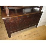 Small 17th Century oak coffer, the hinged lid above a carved three panel front on stile supports,