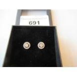 Pair of 18ct yellow and white gold diamond set halo ear studs, approximately 0.66ct