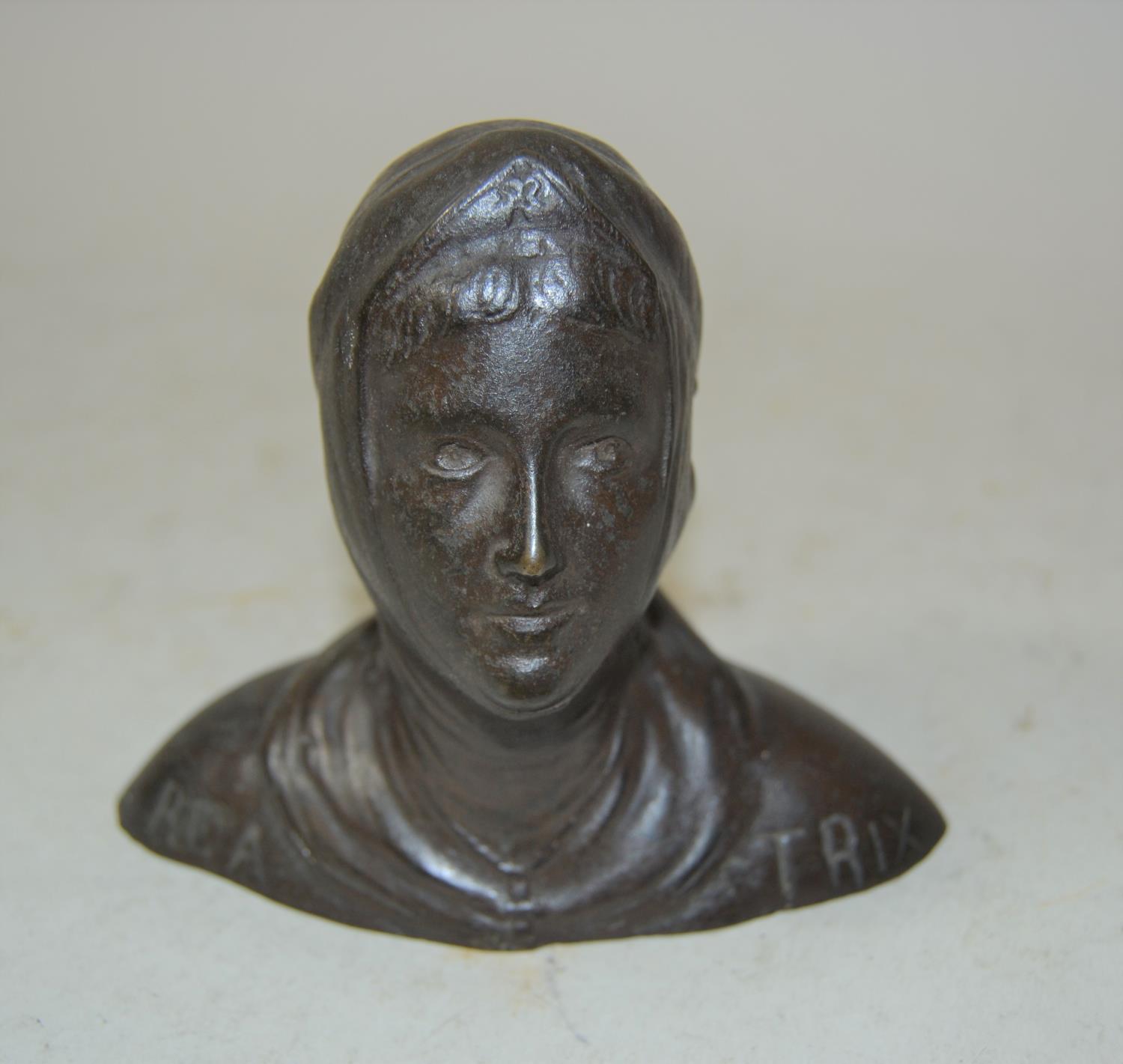 Small brown patinated metal bust of a lady inscribed ' Bea Trix '