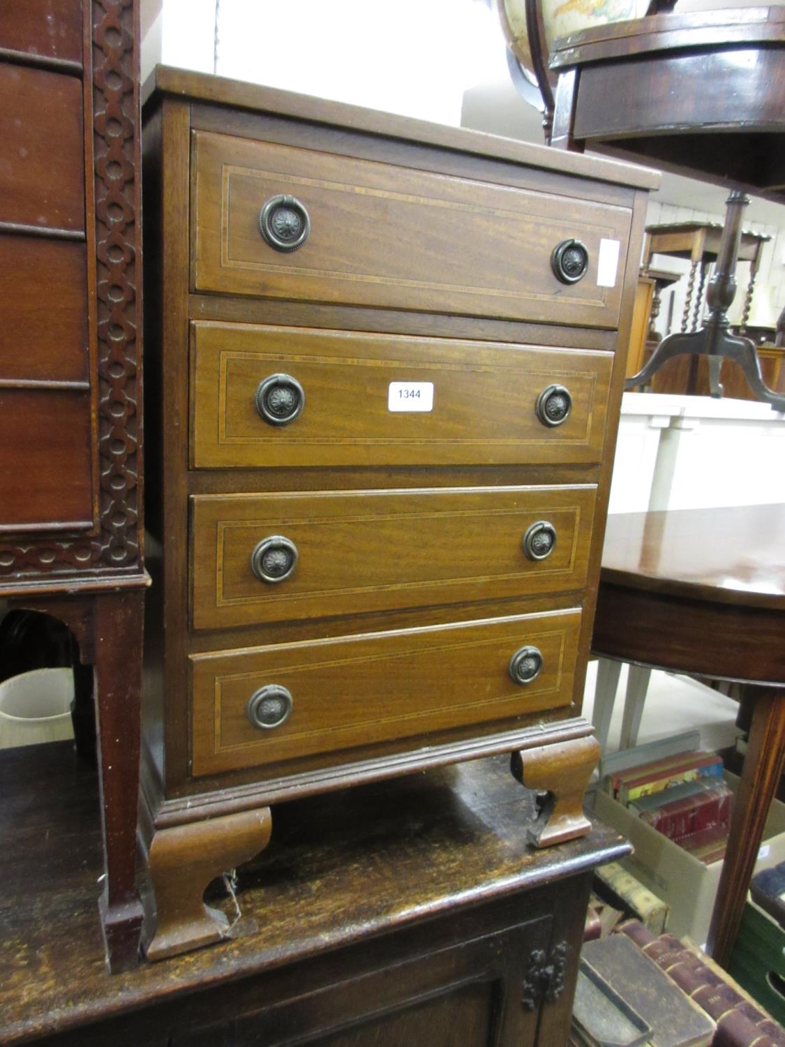 Small reproduction mahogany four drawer chest together with a mahogany shield shaped mirror and a