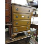 Small reproduction mahogany four drawer chest together with a mahogany shield shaped mirror and a