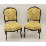 Pair of late 19th / early 20th Century French carved walnut side chairs with gold figured floral