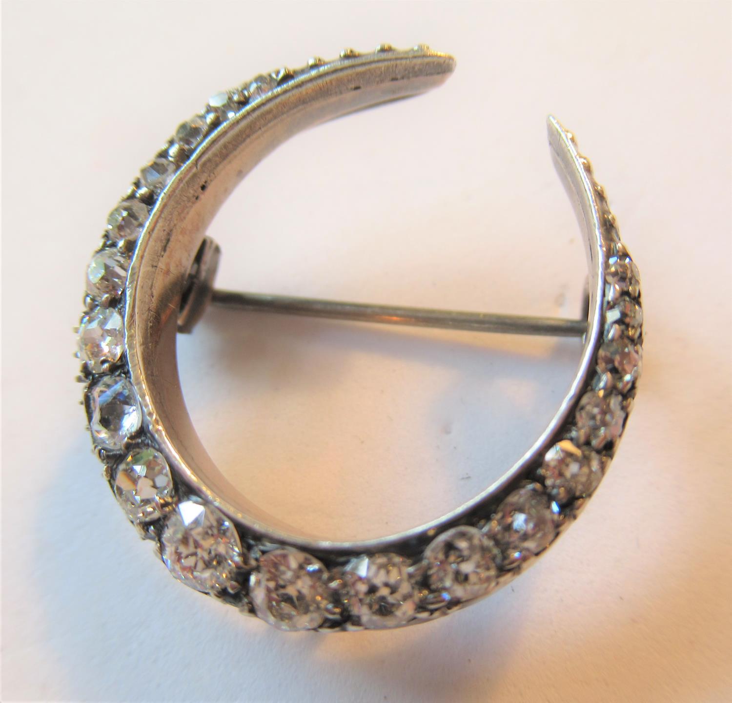 Victorian crescent brooch set graduated old cut diamonds, chip to one stone and frame work in need