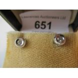 Pair of 9ct yellow and white gold diamond solitaire stud earrings with rub over settings