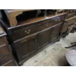 19th Century oak dresser base with three drawers above two panel doors flanking a fixed centre