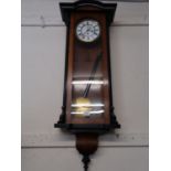 Vienna walnut and ebonised wall clock, the white enamel dial with Roman numerals and subsidiary
