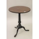George III mahogany circular pedestal table with a plain turned tapering column support and tripod