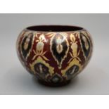 Zsolnay lustre jardiniere decorated with an all-over repeating design on a deep red ground,