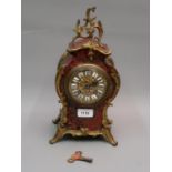 19th Century French buhl ormolu mounted mantel clock, the gilded dial with enamel numerals, with a
