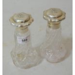 Pair of silver mounted glass perfume bottles, the covers embossed with lily of the valley